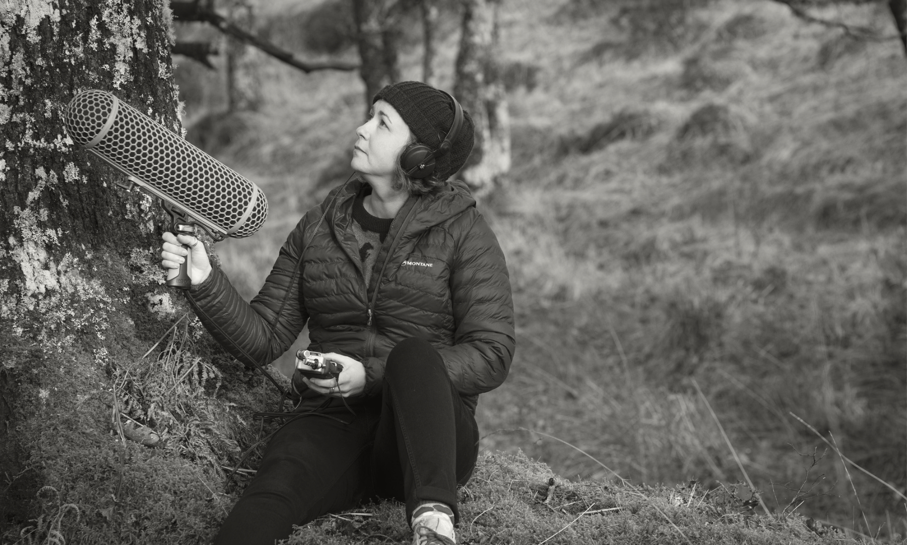 black and white photograph of musician kerrie j robinson under oak tree with large microphone and recording equipment